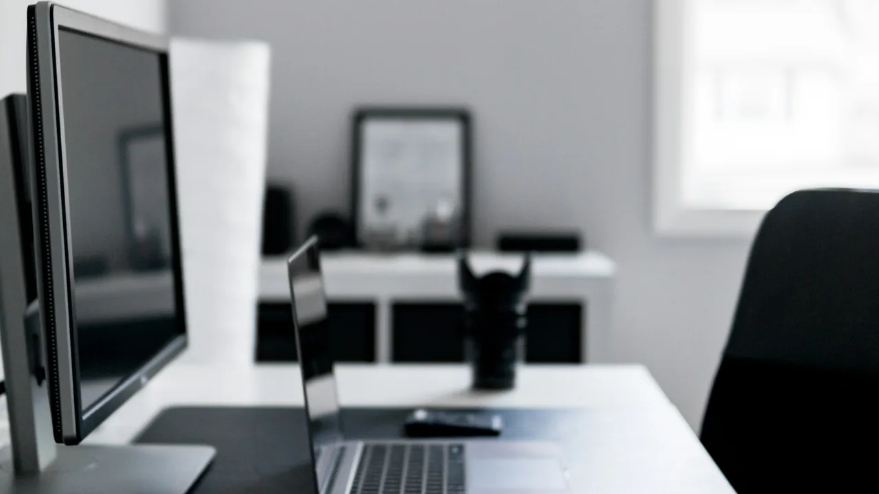 Laptop and monitor on a business workspace desk