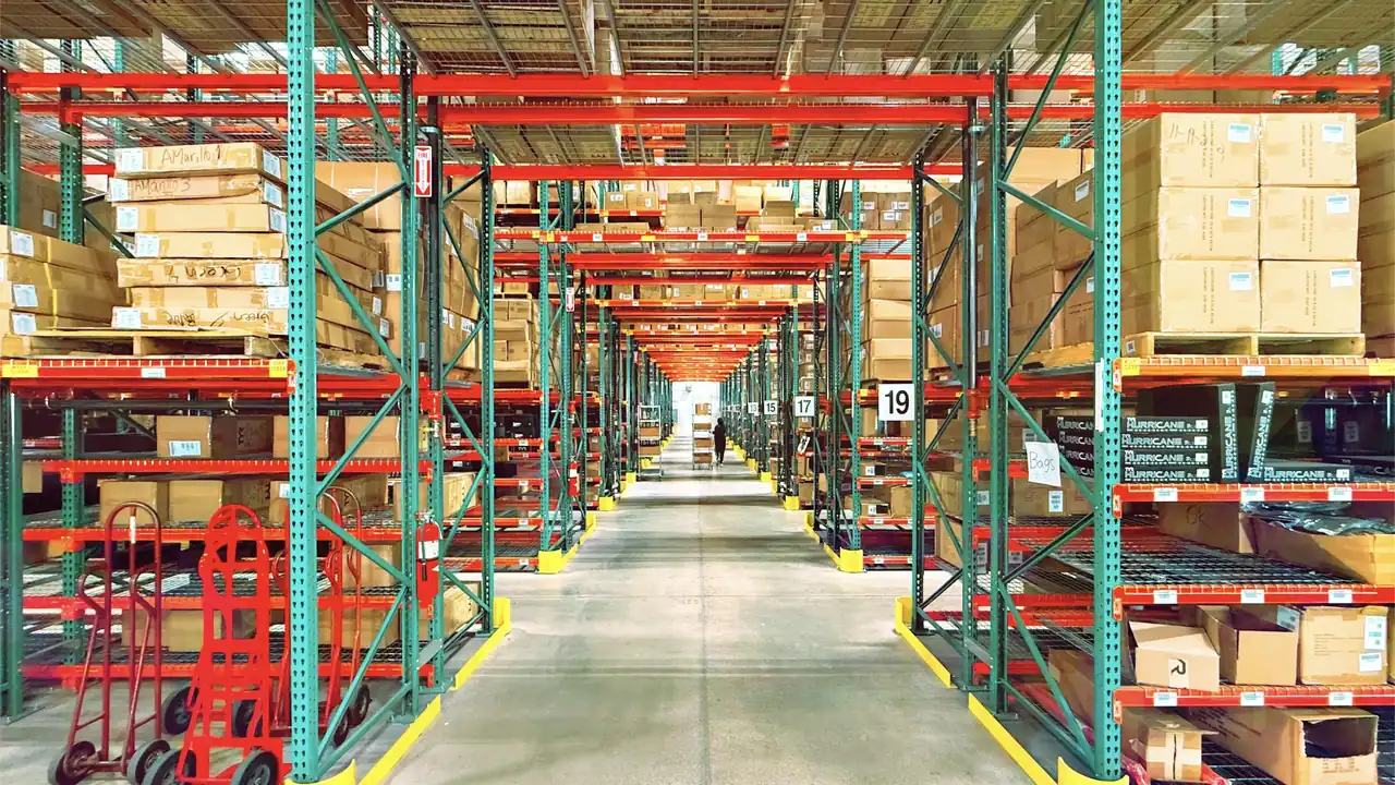 Warehouse aisle lined with tall shelves and boxed inventory
