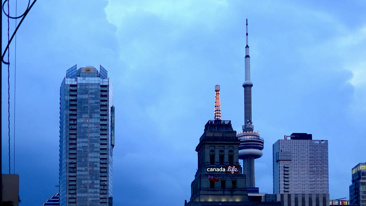 CN Tower and downtown Toronto buildings under a blue evening sky